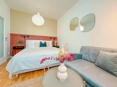 a bedroom with a bed and a vase of flowers on a table at True Relax Apartman 2 bedrooms Wenceslas square in Prague