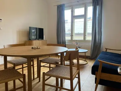 a living room with a table and chairs and a tv at myPoděbrady apartment in Poděbrady