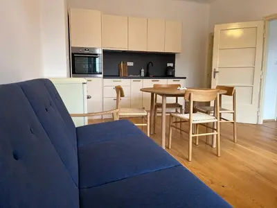 a living room with a blue couch and a table at myPoděbrady apartment in Poděbrady