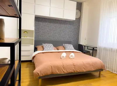 a bedroom with a bed with two towels on it at Lotus Apartment Riverside stay in Prague
