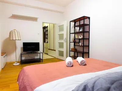 a bedroom with a bed with white towels on it at Lotus Apartment Riverside stay in Prague