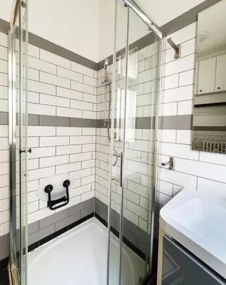 a bathroom with a shower and a sink at Lotus Apartment Riverside stay in Prague