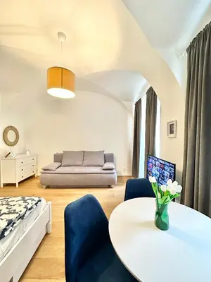 a living room with a bed and a table at The Little Peaceful Retreat in Prague