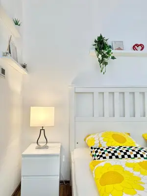 a bedroom with a bed with a lamp on a night stand at The Little Peaceful Retreat in Prague