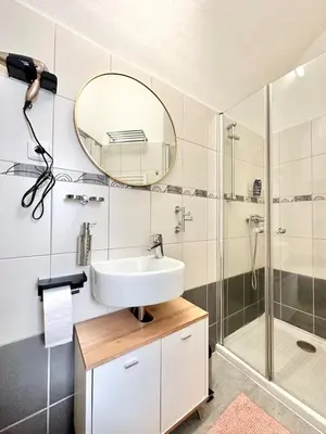 a bathroom with a sink and a shower at The Little Peaceful Retreat in Prague
