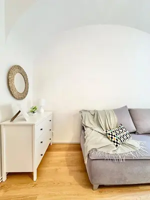 a living room with a couch and a white dresser at The Little Peaceful Retreat in Prague