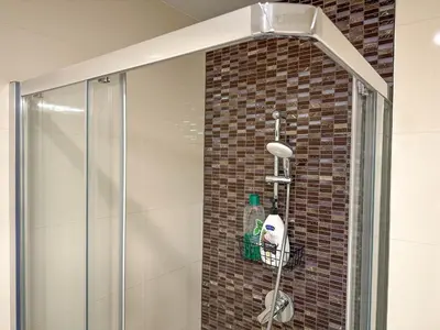 a shower in a bathroom with a glass shower stall at Elegant Apartment Near Main Station & Wenceslas Sq in Prague