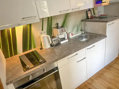 a kitchen with a sink and a counter top at Elegant Apartment Near Main Station & Wenceslas Sq in Prague