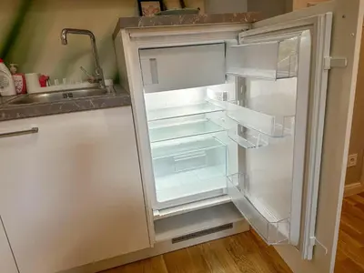 an empty refrigerator with its door open in a kitchen at Elegant Apartment Near Main Station & Wenceslas Sq in Prague