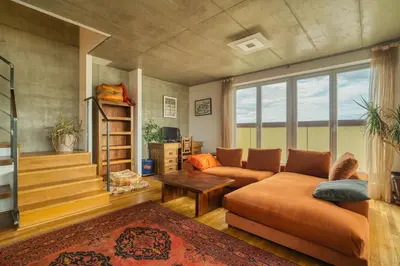a living room with a couch and a table at LOcelot Premium 2 floor Apartment near O2 Arena in Prague