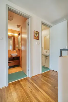 a bathroom with a toilet and a sink and a mirror at LOcelot Premium 2 floor Apartment near O2 Arena in Prague