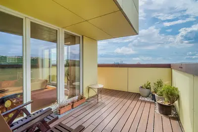 a balcony of a house with a deck with plants at LOcelot Premium 2 floor Apartment near O2 Arena in Prague