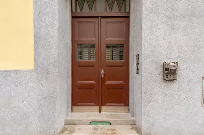 a brown door on the side of a building at Live like a local family in Letna in Prague