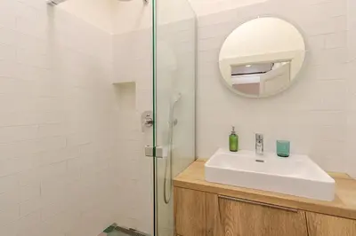 a bathroom with a sink and a mirror at Live like a local family in Letna in Prague