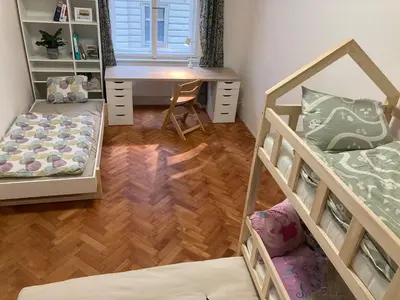 a dorm room with a desk and a bunk bed at Live like a local family in Letna in Prague