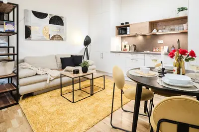 a living room with a couch and a table at Prague Days - One-bedroom Apartment with Netflix and High Speed WiFi in Karlín in Prague
