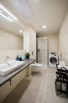 a bathroom with a sink and a washing machine at Prague Days - One-bedroom Apartment with Netflix and High Speed WiFi in Karlín in Prague