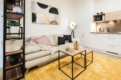 a living room with a couch and a table at Prague Days - One-bedroom Apartment with Netflix and High Speed WiFi in Karlín in Prague