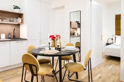 a kitchen and dining room with a table and chairs at Prague Days - One-bedroom Apartment with Netflix and High Speed WiFi in Karlín in Prague