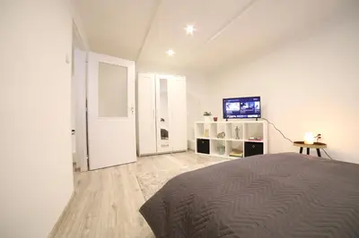 a bedroom with a bed and a flat screen tv at Chill Vibes Netflix, PS5 & Free Parking! in Prague