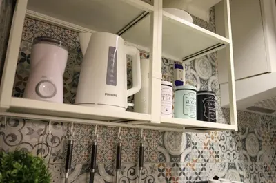 a kitchen shelf with bottles of products on it at Chill Vibes Netflix, PS5 & Free Parking! in Prague