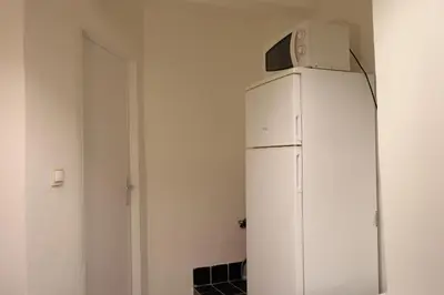 a white refrigerator with a microwave on top of it at Chill Vibes Netflix, PS5 & Free Parking! in Prague