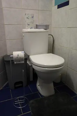 a bathroom with a white toilet in a room at Chill Vibes Netflix, PS5 & Free Parking! in Prague