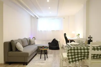 a living room with a couch and a table at Chill Vibes Netflix, PS5 & Free Parking! in Prague