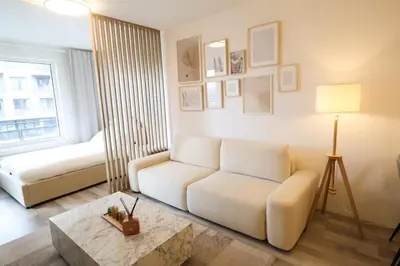 a living room with a couch and a coffee table at Leo Cozy Flat Big Balcony Prague in Prague