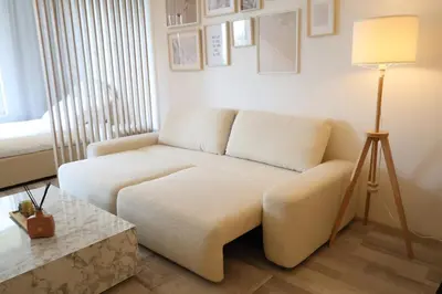 a living room with a white couch and a lamp at Leo Cozy Flat Big Balcony Prague in Prague