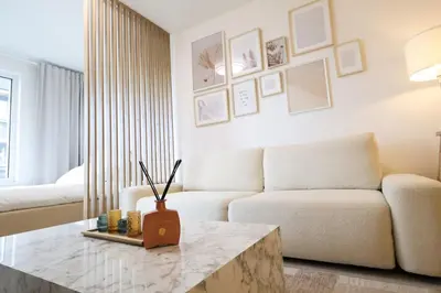a living room with a couch and a table at Leo Cozy Flat Big Balcony Prague in Prague