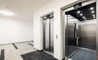a elevator in a building with a glass door at Leo Cozy Flat Big Balcony Prague in Prague