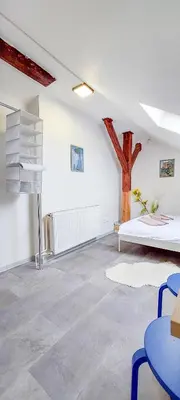 a room with a bed and a cross on the wall at Soukromý pokoj Milada in Prague
