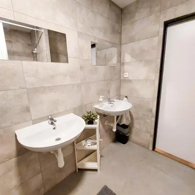 a bathroom with two sinks and a mirror at Soukromý pokoj Milada in Prague