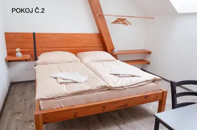a bed with two pillows on it in a room at Pivovar Kulivá Hora in Třebotov