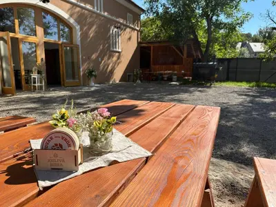 a wooden table with flowers and a box on it at Pivovar Kulivá Hora in Třebotov