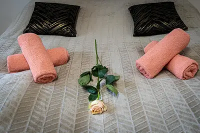 a group of four rolled up towels on a bed at Modern Deluxe Suite in Prague