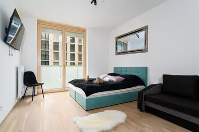 a person laying on a bed in a living room at Modern Deluxe Suite in Prague