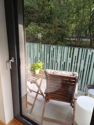 a living room with a couch and a table at 10min to the center Modern Flat in Prague
