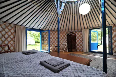 a room with a bed with two towels on it at Idyllic Yurt with Organic Fruit Garden near Cesky Brod, Czech Republic in Český Brod