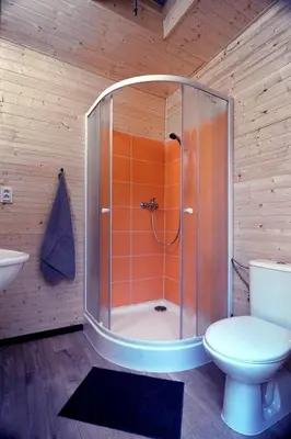 a bathroom with a shower with a toilet and a sink at Idyllic Yurt with Organic Fruit Garden near Cesky Brod, Czech Republic in Český Brod