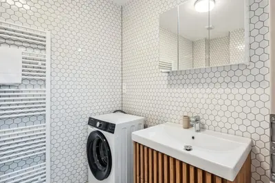 a bathroom with a washing machine and a sink at Spacious two-storey apartment with a terrace in the city center in Benešov