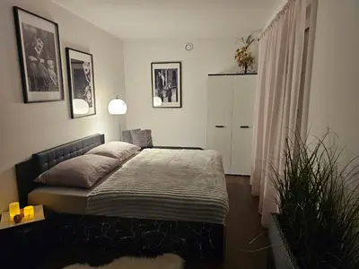 a bedroom with a bed and a plant in it at Sun Prague - Stodůlky in Prague