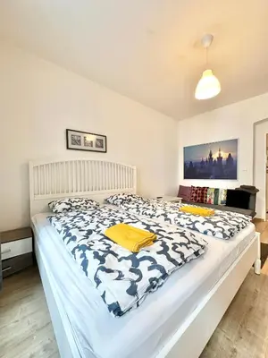 a bedroom with a large bed with a blue and white comforter at The Little Peaceful Retreat Near Center in Prague