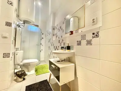 a white bathroom with a sink and a toilet at The Little Peaceful Retreat Near Center in Prague