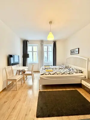 a bedroom with a bed and a table and chairs at The Little Peaceful Retreat Near Center in Prague