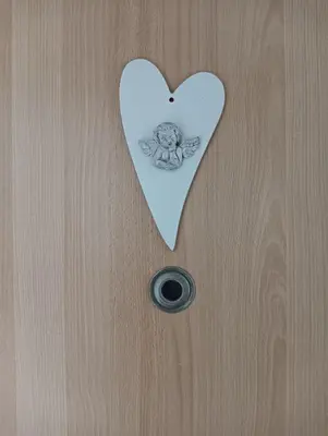 a door with a heart cut out of it at Sweet home apartment Kobylisy in Prague
