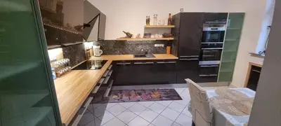 a kitchen with black cabinets and a counter top at Sweet home apartment Kobylisy in Prague