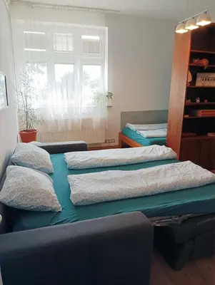 a bedroom with two beds with pillows on them at Sweet home apartment Kobylisy in Prague