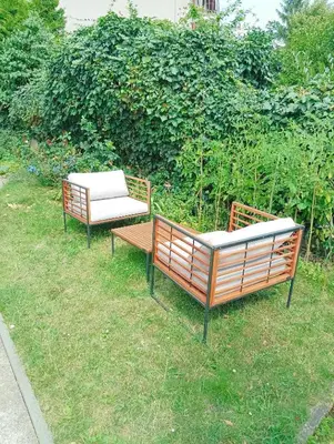 two benches sitting on the grass in a yard at Sweet home apartment Kobylisy in Prague